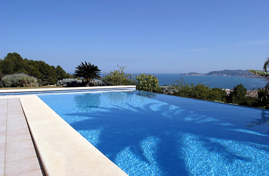 beautiful blue fresh infinity swimming pool in a villa in sunny