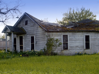 Fototapeta na wymiar abandoned house with sinking roof