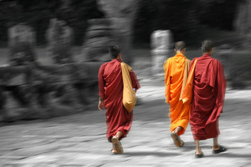 a group of monks leave one of the angkor temples