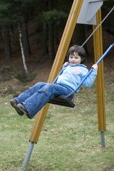 5 years old girl playing on a see-saw