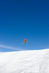 Naklejka na ściany i meble man skiing on slopes of ski resort in spain