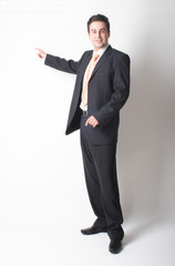 standing  businessman in suit pointing at chart