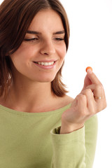 stock photo of a young woman taking pill