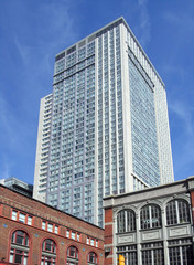 highrise condominium behind older buildings