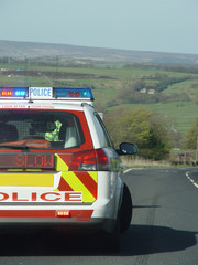 police car and slow sign