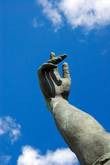 stone hand in a blue sky