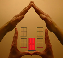 hands holding red house