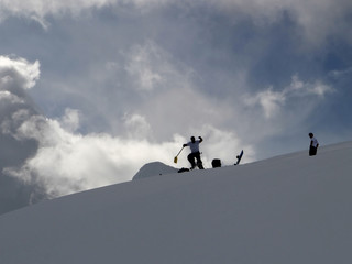 snowboarders building a jump