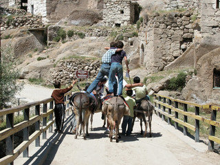boys riding donkeys in ihlara valley. cappadocia,