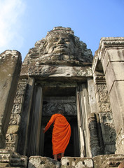 a monk enters bayon temple at angkor thom, cambodi © Richard Connors