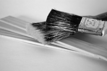 grungy paintbrushes on paint stirrers