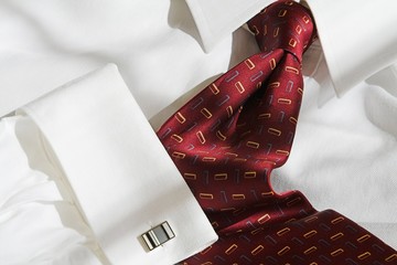 red necktie and dress shirt with cufflink