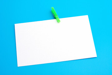 isolated white paper with green clamp