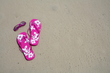 flip-flops and sun glasses on the sand