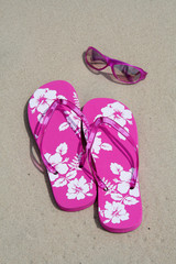flip-flops and sun glasses on the sand