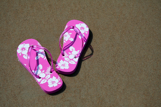 pink flip-flops on the sand