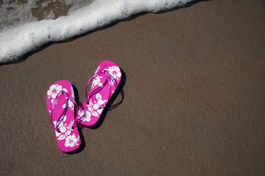 pink flip-flops on the sand