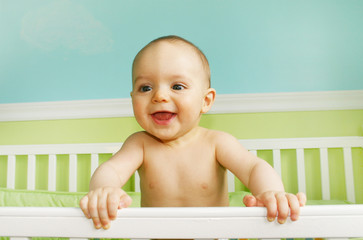 baby boy playing in crib
