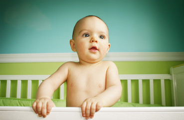 baby boy playing in crib