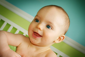 baby boy smiling in crib