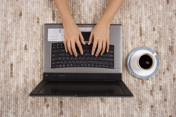 woman working home on the carpet (close)