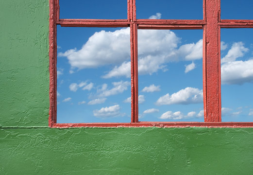 blue coudy sky through old house window