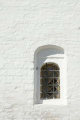 window in a wall of monastery