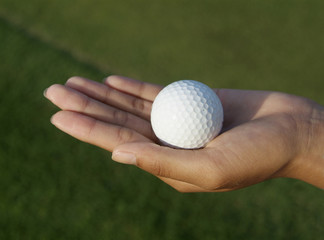 hand holding a golf ball