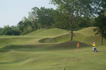 golf player and caddie on fairway