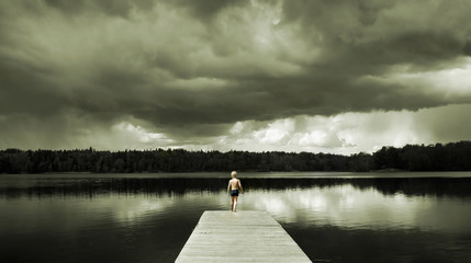 boy standing on a footbridge