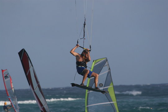 kiter jumping amongst windsurfers