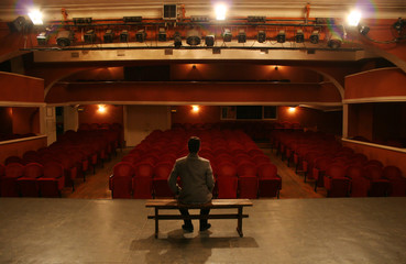 man alone on theater scene