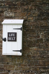 life belt box on stone wall
