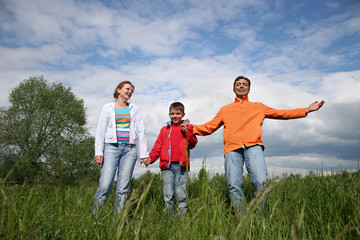 happy family stand in grass