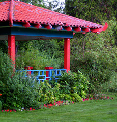 chinese pagoda-style gazebo amidst plants and trees (i)