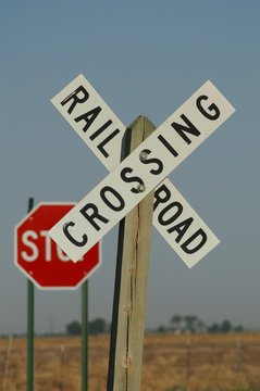 white cross railroad sign, vertical