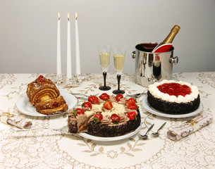 dessert table with cakes and champagne