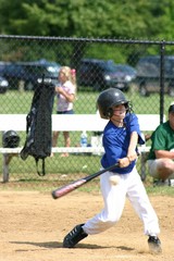 boy hitting baseball