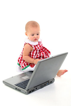 baby girl with laptop computer over white