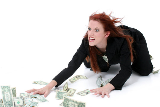 crazed business woman grabbing money from floor