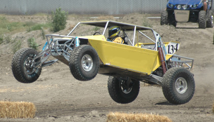 yellow sand car leaping in air