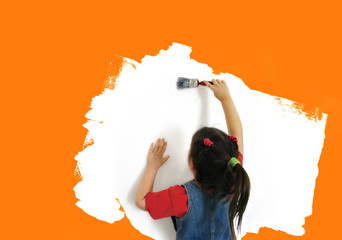 little girl painting an orange wall