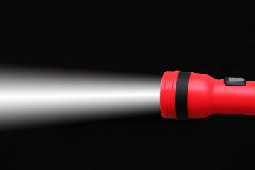 flashlight and beam on black background