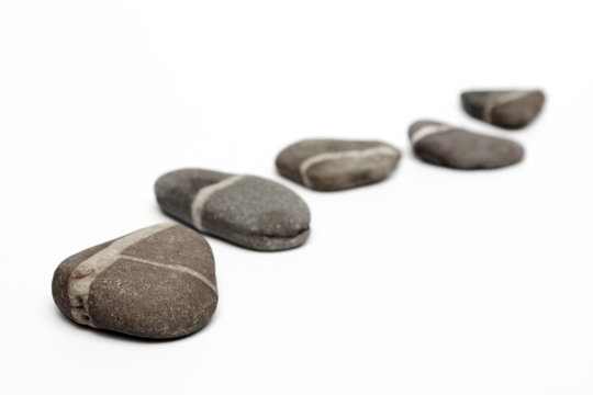 Row of stepping stones on white background