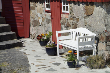 white bench and old house