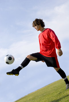 Soccer - Football Player Juggling In Red