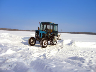 tractor removing snow in the winter