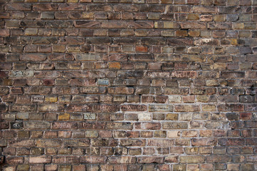 brick wall background with names scratched
