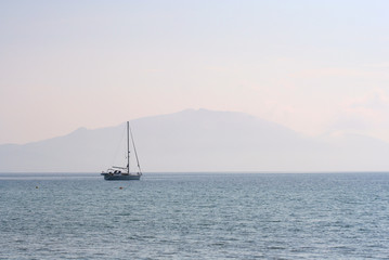 yacht & misty mountain at dusk