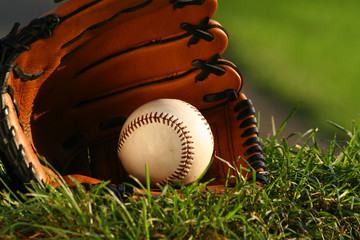 baseball and glove on the grass after the big game